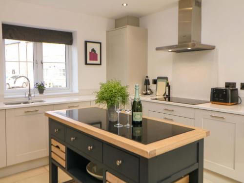a kitchen with a counter with a bottle of wine at Knoll View in Bradwell