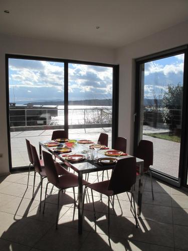 a dining room with a table and chairs and a large window at The Beach House in Sozopol
