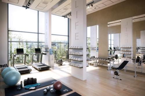 a large room with a gym with large windows at Modern 1Bed Apt with Parking - Grand Exchange Bracknell in Bracknell