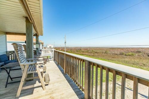 a porch of a house with two rocking chairs on it at Breathtaking Island Views from Multiple Decks! in Surfside Beach