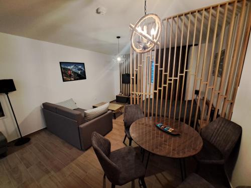 a living room with a table and a couch at Twin mountain in Kopaonik