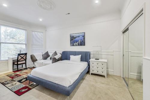 a bedroom with a bed and a couch and a chair at In the Heart of Haight Ashbury 5 Bedroom House in San Francisco