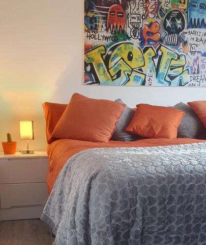 a bedroom with a bed with a painting on the wall at 3 bedroom guest House in Brierley hill Contractors & Families Welcome DY5 in Woodside