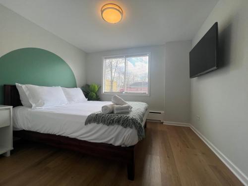 a bedroom with a large bed with a window at Serenity & Style With Parking in Lombard