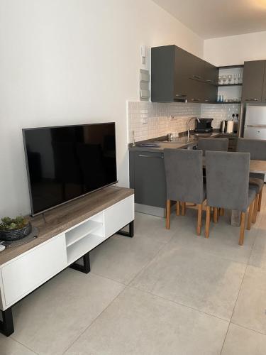a kitchen with a large entertainment center with a flat screen tv at Deja Blue, block S4, unit 26 in Bahçeli