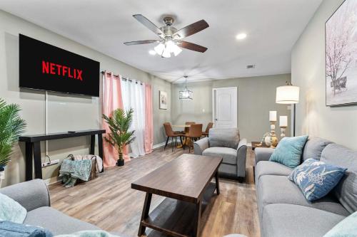 a living room with a couch and a tv at Renovated Home Perfect for Family in Mobile