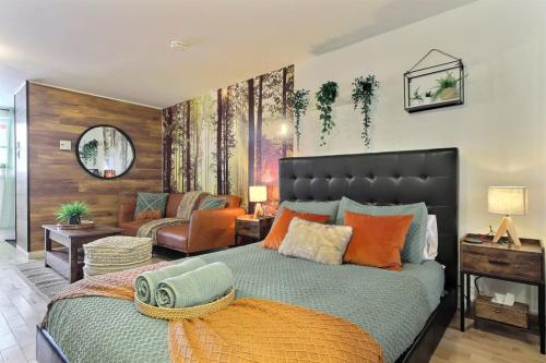 a bedroom with a large bed and a living room at Enchanting Loft - Fireplace AC Quebec Downtown in Quebec City
