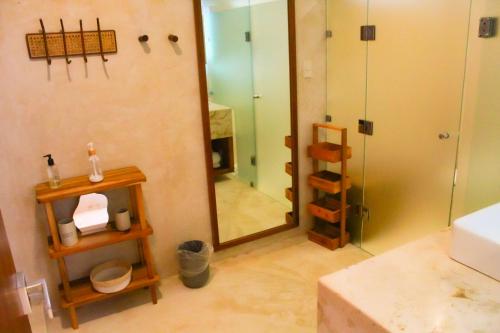 a bathroom with a large mirror and a shower at Lipsos Private Luxury Beachfront home in Progreso