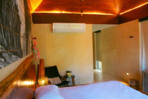 a bedroom with a bed and a living room at Lipsos Private Luxury Beachfront home in Progreso