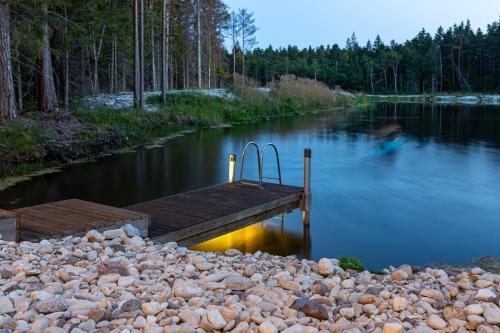 a dock in the middle of a body of water at Roostajärve Minivilla in Elbiku