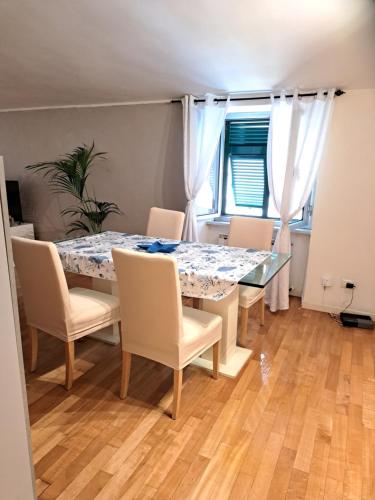 a dining room with a table and chairs at La Mansarda di Ale in La Spezia