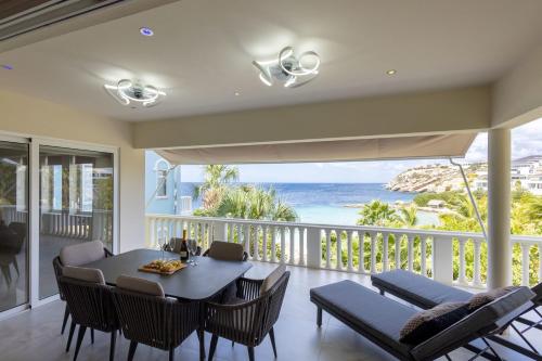 a dining room with a view of the ocean at Blue Emerald at Blue Bay Beach & Golf Resort in Sint Michiel