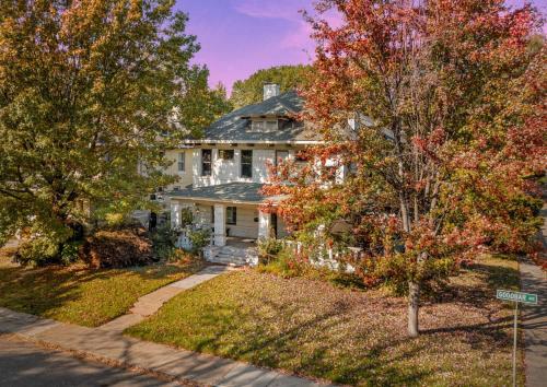a large white house with trees in front of it at Pool Outdoor TV Fire Pit Game Room in Memphis