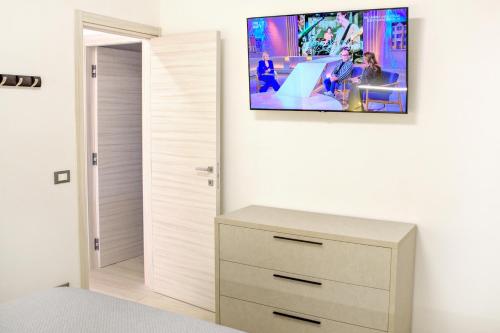a bedroom with a tv hanging on the wall at Locazione Turistica Arcobaleno "Appartamento Deluxe" in Roccavivara