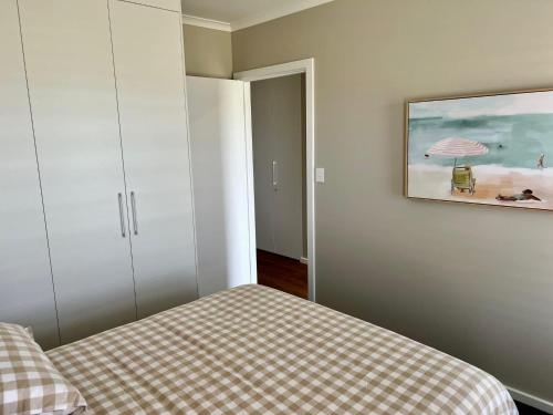 a bedroom with a bed and a painting on the wall at Foxhill Shores - WIFI outside pets in Robe