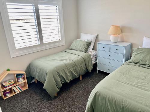 a bedroom with two twin beds and a window at Foxhill Shores - WIFI outside pets in Robe
