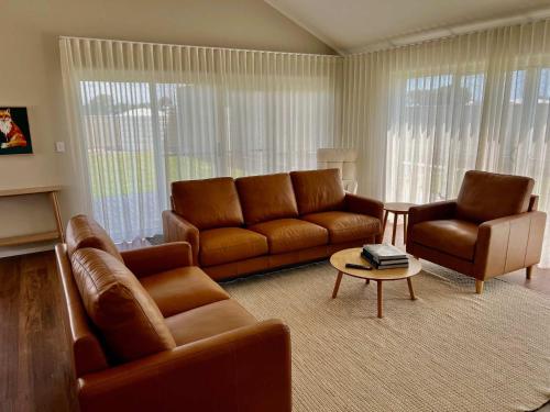 a living room with a couch and two chairs at Foxhill Shores - WIFI outside pets in Robe