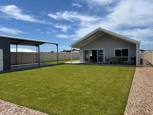 a house with a large lawn in front of it at Foxhill Shores - WIFI outside pets in Robe