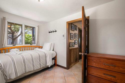 a bedroom with a bed and a window at Unique waterfront home with stunning views in Wellfleet