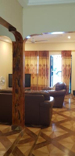 a living room with couches and a tree in a room at The bb's in Jamisa