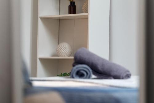 a rolled up towel sitting on top of a bed at City Centric 1BR Apartment in Bradford