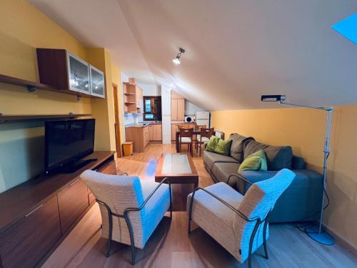 a living room with a couch and chairs and a table at Apartamento Espata VII in Villanúa