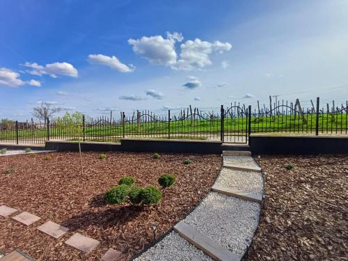 a garden with a fence and some plants at Welcome House Eger in Eger