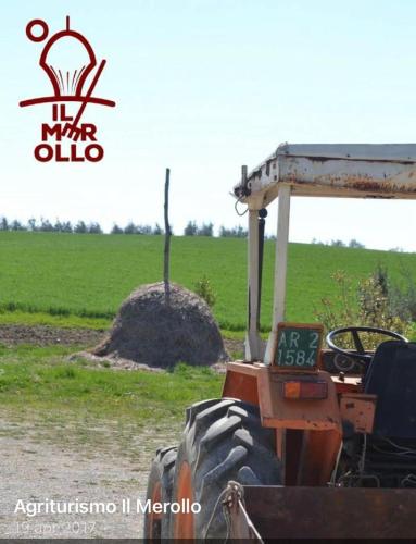 a tractor parked in front of a field at Agriturismo Il Merollo in Todi