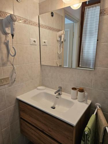 a bathroom with a sink and a mirror at Vista Lago in Luino