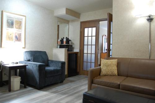 a living room with a couch and a chair at Quality Inn Homestead Park in Billings