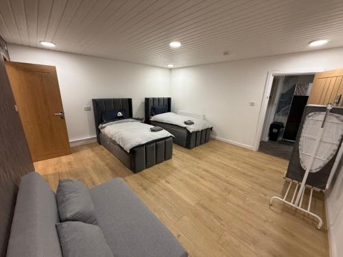 a living room with two beds and a couch at Birmingham City Centre- 9 bed house with free parking in Birmingham