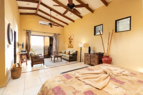 a bedroom with a bed and a living room at Luxury Flamingo villa with outdoor bar - pool and magnificent views in Playa Flamingo