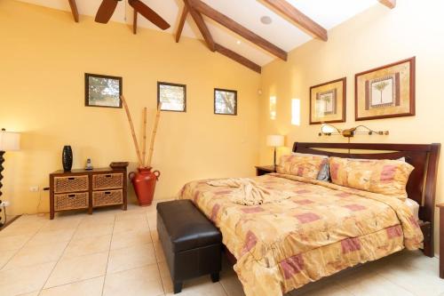 a bedroom with a bed and a vase in it at Luxury Flamingo villa with outdoor bar - pool and magnificent views in Playa Flamingo