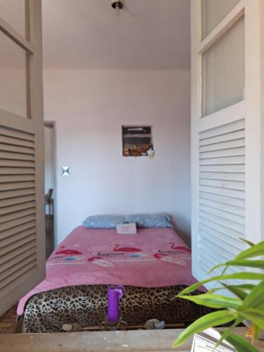 a bed in the corner of a room at Casa Por do Sol in Rio de Janeiro