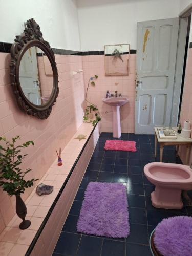 a pink bathroom with a sink and a toilet at Casa Por do Sol in Rio de Janeiro