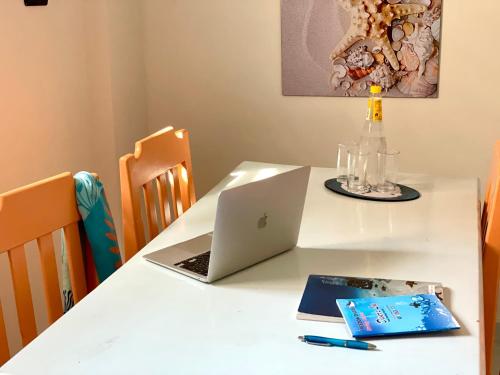 a white table with a laptop computer on it at Divers Home Safaga in Safaga 