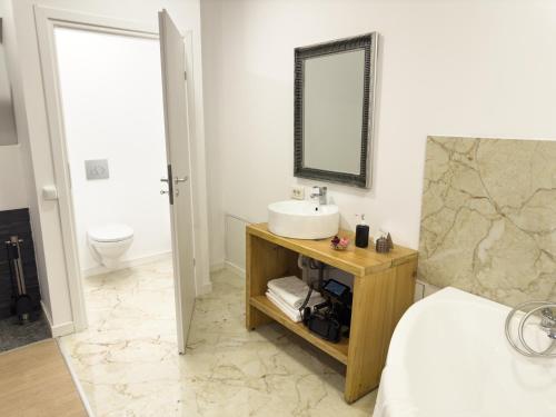 a bathroom with a sink and a mirror at MiddleHouse in Braşov