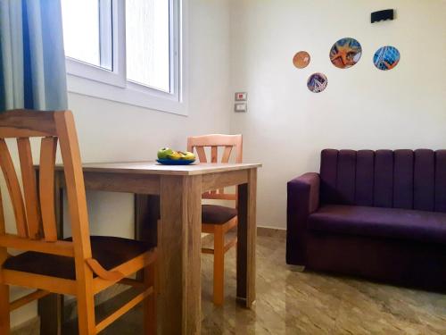 a room with a table and a chair and a couch at Divers Home Safaga in Safaga 