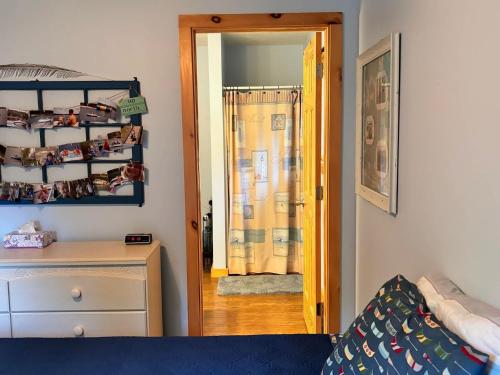 a bedroom with a bed and a door leading into a room at Beautiful Retreat on Sand Lake in Irons