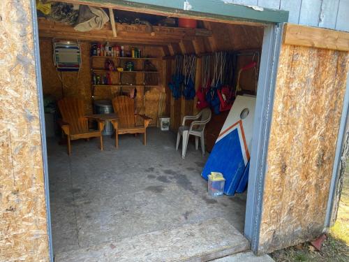 an outside view of a small house with a table and chairs at Beautiful Retreat on Sand Lake in Irons
