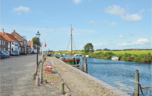 a river with boats parked on the side of a street at Holiday Home Kærbølvej in Ribe