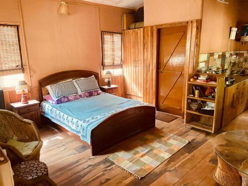 a bedroom with a large bed in a room at The Wild Escape in Kālādhūngi