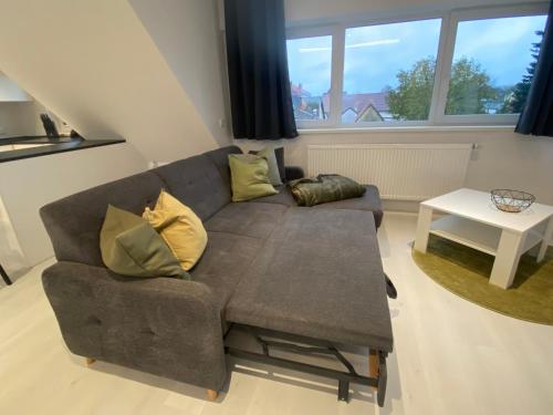 a living room with a couch and a table at modernes DG Apartment Schloofschdubb Nähe Kassel in Fuldatal