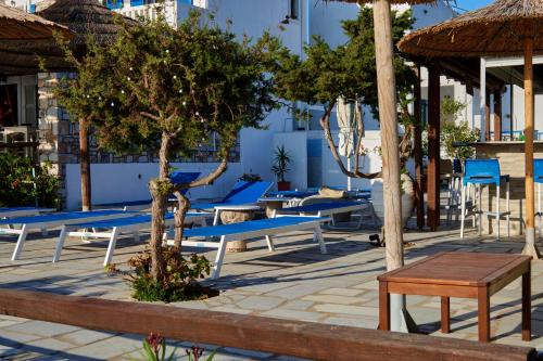 a row of blue benches and tables on a patio at Theologos Beach in Antiparos Town