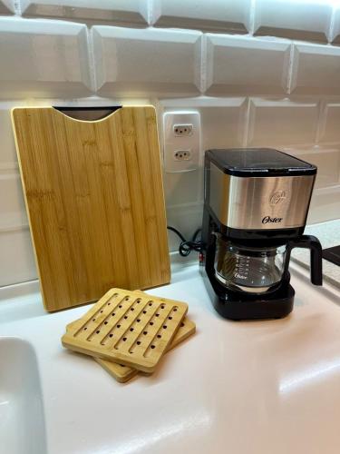a coffee maker sitting on top of a counter next to a blender at Studio Contemporâneo - Centro RJ in Rio de Janeiro