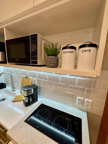 a kitchen with a sink and a microwave at Studio Contemporâneo - Centro RJ in Rio de Janeiro