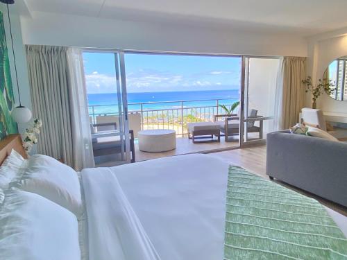 a bedroom with a bed and a view of the ocean at Panoramic Oceanview Resort - Full Kitchen in Each Unit, 2 Swimming Pools, Onsite Restaurants, Fireworks Every Friday in Honolulu