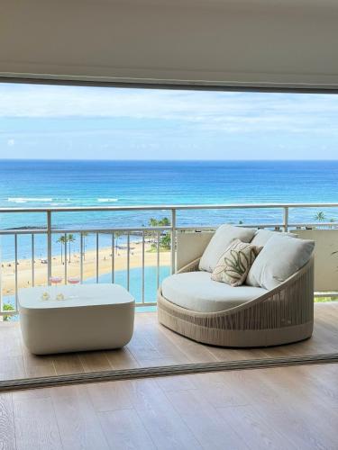 a room with a bed and a view of the beach at Panoramic Oceanview Resort - Full Kitchen in Each Unit, 2 Swimming Pools, Onsite Restaurants, Fireworks Every Friday in Honolulu