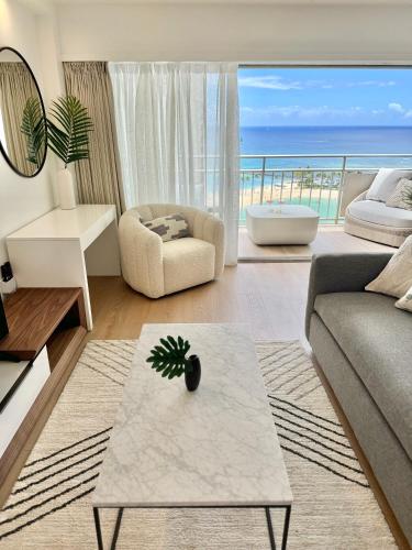 a living room with a view of the ocean at Panoramic Oceanview Resort - Full Kitchen in Each Unit, 2 Swimming Pools, Onsite Restaurants, Fireworks Every Friday in Honolulu