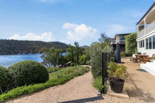 a house with a patio with a view of the water at Karinya apartment waterfront views - 2 Bed 2 Bath in Lindisfarne